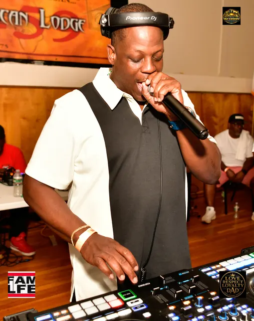 The DJ on the mic behind the decks