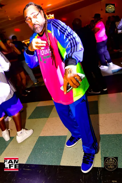 Guest dancing in a color-block adidas track suit