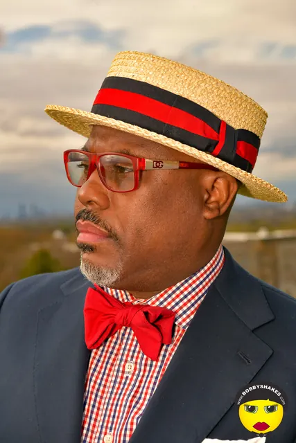 Guest in a straw boater and red bow tie