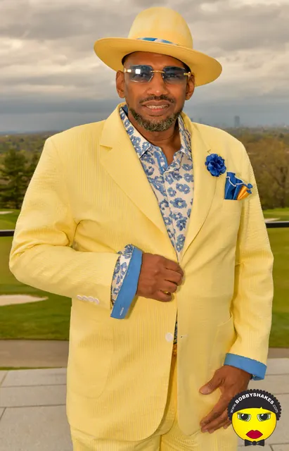 Guest in a yellow suit and matching straw hat